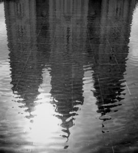A black & white photograph of the Salt Lake City LDS (Mormon) Temple, reflected in the water of the reflecting pool. Photo by Paul Duane.